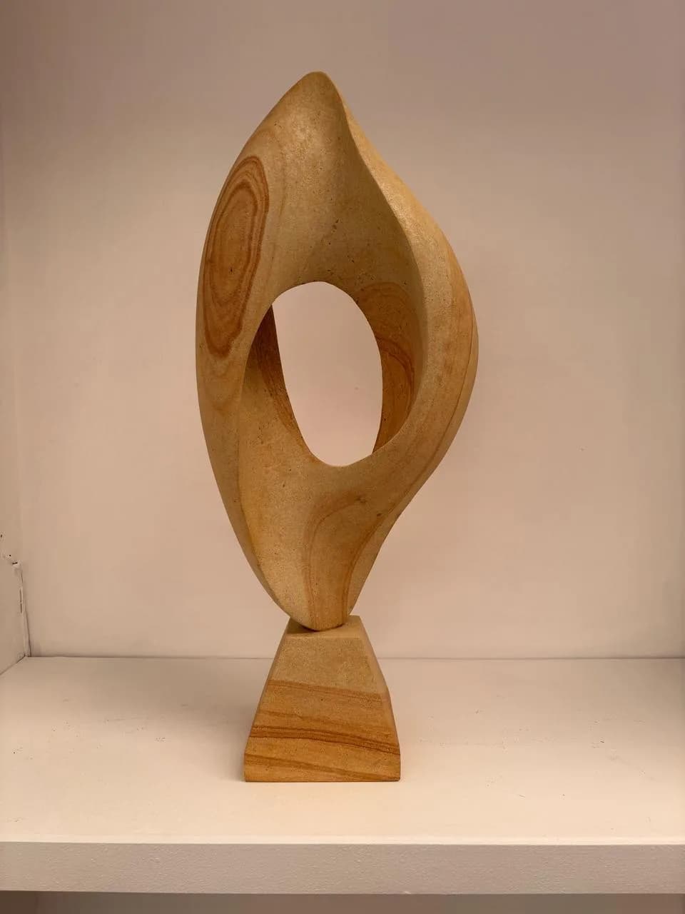 Limestone Sculpture #1 by Omar Yepez, tall abstract carved limestone form with an open oval void at El Dorado Gallery